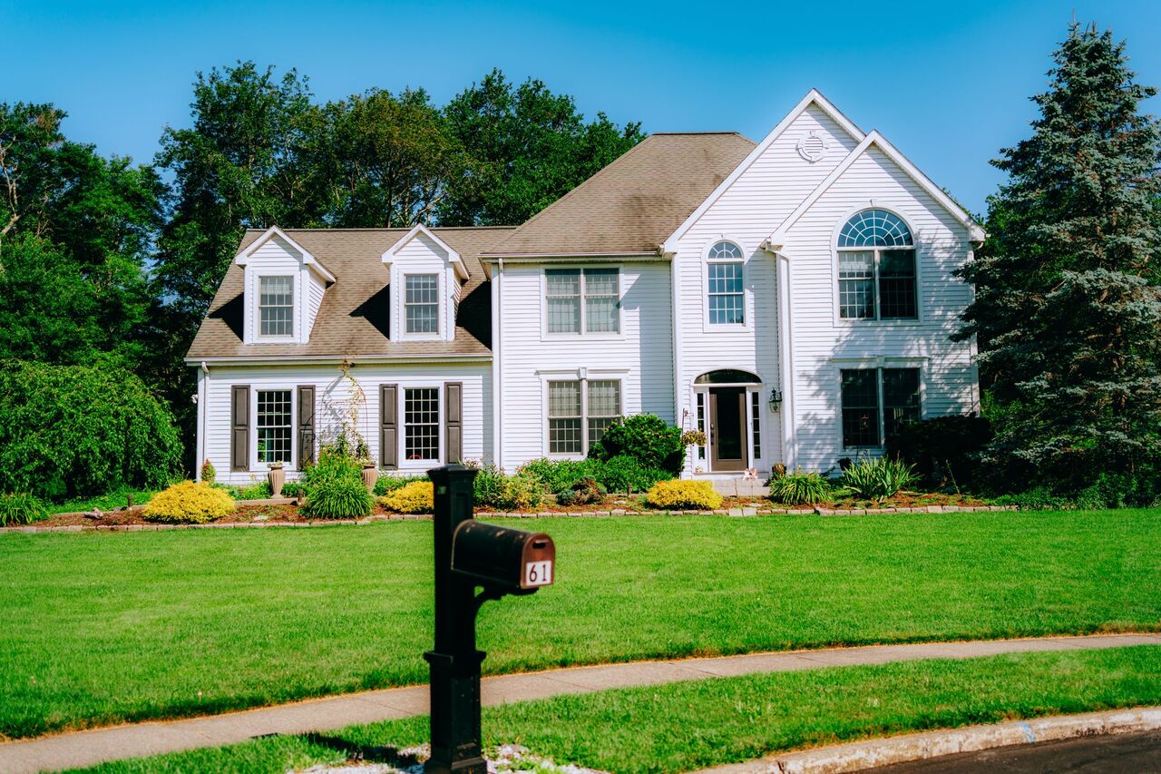 Two-story suburban home with a manicured front lawn